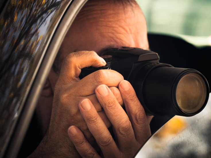 undercover man detective hidden in car secretly take photo Bild: Coka/stock.adobe.com